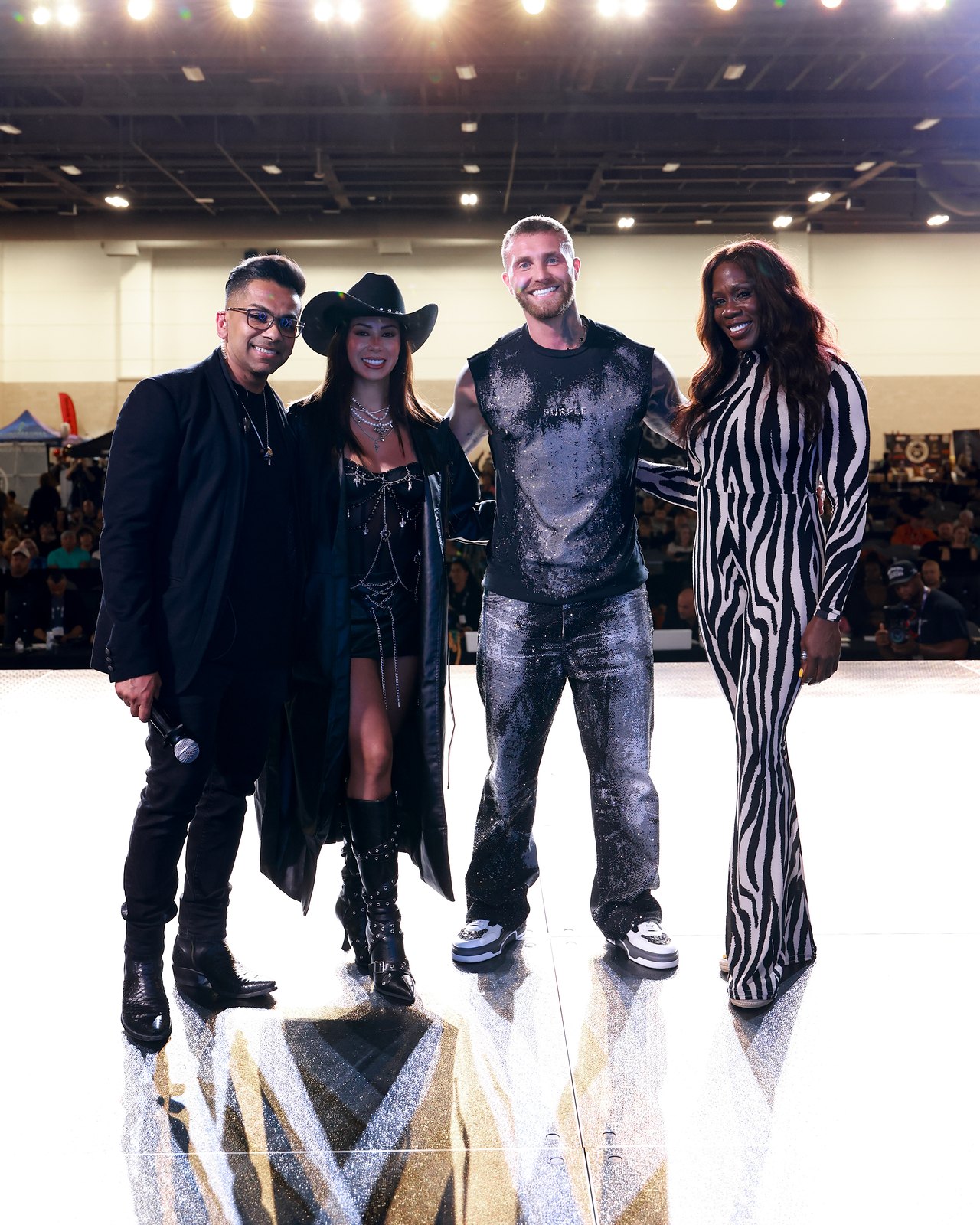 PWRHOUSE Production: four people standing together on the event stage under the lights